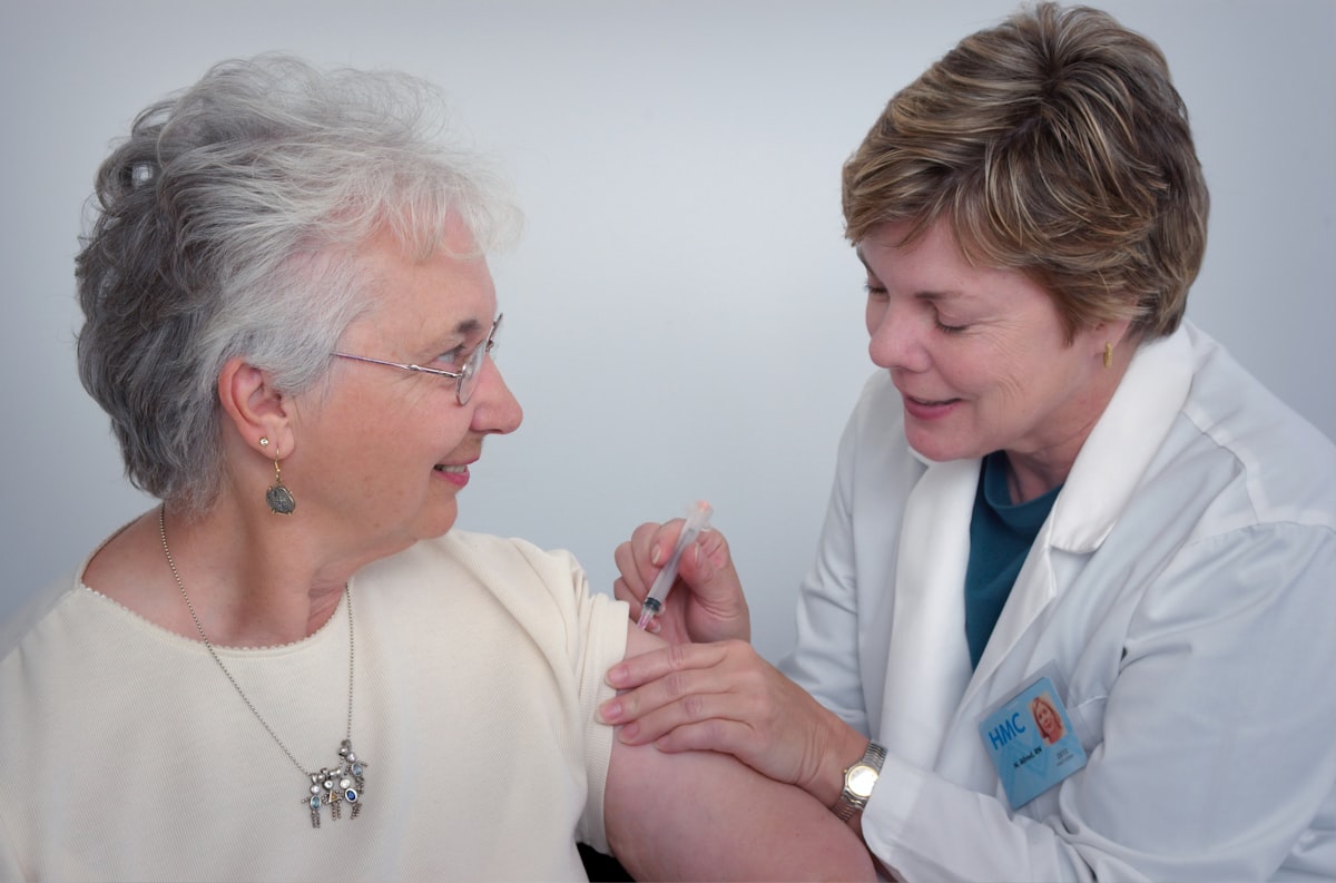 A nurse giving a patient a vaccination